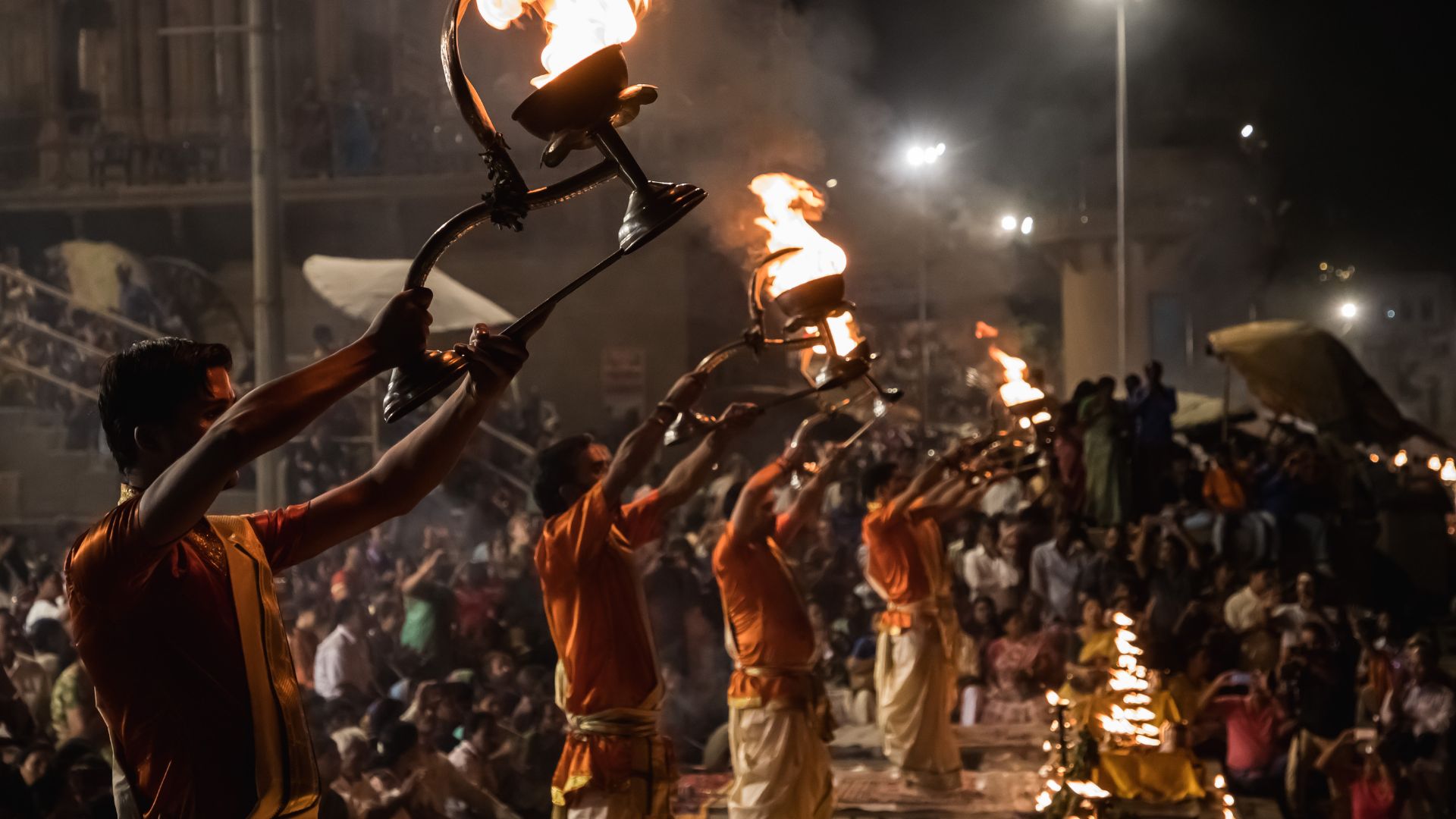 Ganga Aarti ceremony with priests holding brass lamps at Haridwar
